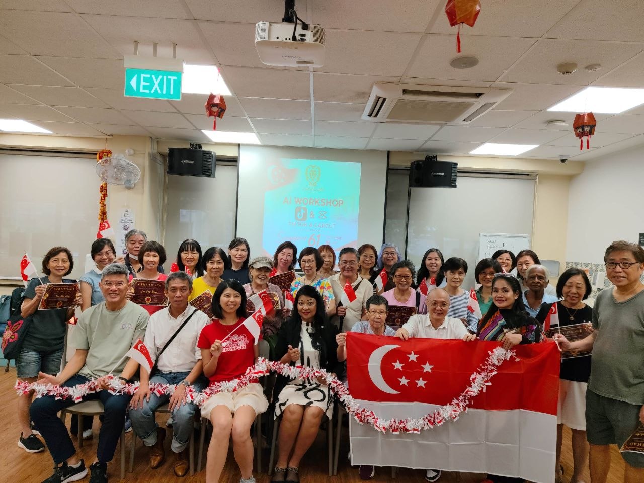 Sagelion workshop participants with certificates and a Singapore flag
